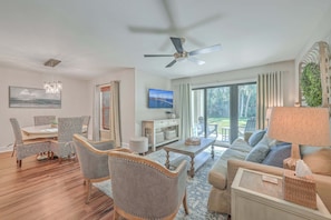 A living room with a dining area, a ceiling fan, a television, and a view of the outdoors. - 138 High Hammock (Seabrook Island)
