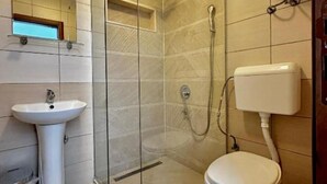 A bathroom with a glass-enclosed shower, a pedestal sink, and a toilet. - Casa Mila Apartments - Standard Triple bedroom with sea view (Ulcinj)