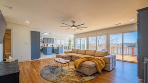 A spacious living area with a large sectional sofa, a wooden coffee table, and a rug. - Private Dock & Hot Tub: Lakefront Eufaula Escape (Eufaula)