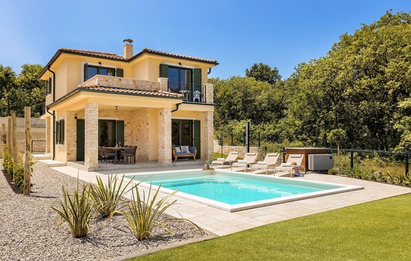 A two-story house with a swimming pool, outdoor seating, and a stone facade. - Amazing home in Vrbnik with sauna (Vrbnik)