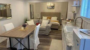A modern kitchen with a marble countertop and a built-in dishwasher. - Golden Spa Suite (Port Franks)
