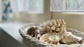 A wicker basket containing decorative items on a windowsill.