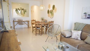 A modern living room with a wooden dining table, chairs, a glass coffee table, and a brown sofa. - Ap2236 in Denia With 2 Bedrooms and 2 Bathrooms (Denia)
