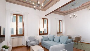 A modern living room with a sofa, armchairs, a coffee table, and a dining table. - Ruote 42 by Wynwood House (Florence)