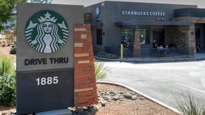 A Starbucks Coffee sign with a 'Drive Thru' label and the address 1885.