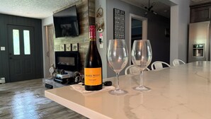 A kitchen with a marble countertop, a wine bottle, and two wine glasses. - 10 acres property great for outside activities its great place to make memories (Walton)