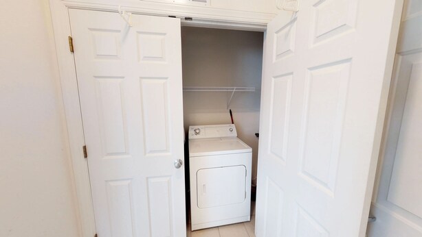A laundry room with a washing machine and a drying rack. - Champions Unit 3612 (Sunset Beach)