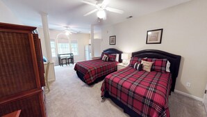A bedroom with two beds, a desk, and a chair. - Champions Unit 3417 (Sunset Beach)