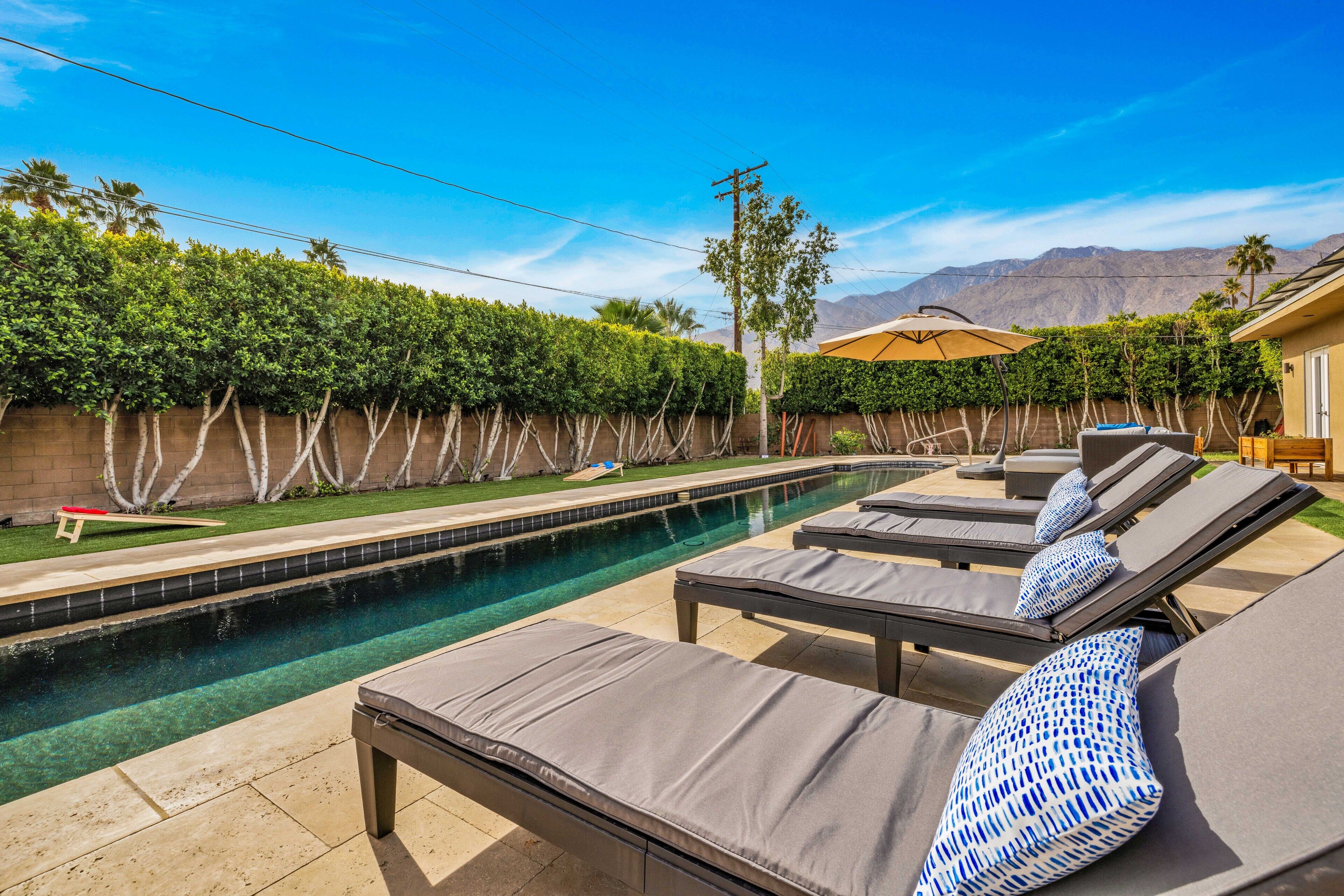 A pool area with lounge chairs and a small pool.