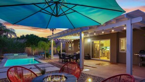 A backyard with a pool, outdoor seating, and a pergola. - Shannon (Palm Springs)