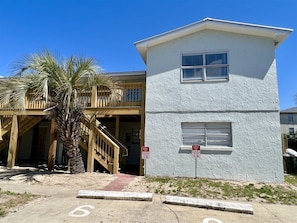 A two-story building with a white exterior and a wooden deck. - Waymar Isle 6 - Beach Walk (Fort Walton Beach)
