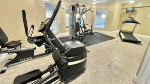 A gym with cardio machines, weight training equipment, and a treadmill. - Waters Edge 404 - Okaloosa Dreamin' (Fort Walton Beach)