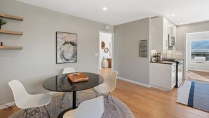 A modern kitchen with white cabinets, a built-in oven, and a microwave. - Marbella Lane - Chic Abode w Mountain Skyline (Pacifica)