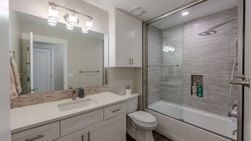 Bathroom with a tub and shower