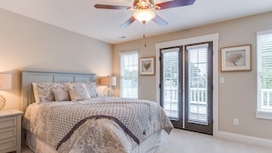 A bedroom with a bed, nightstands, a ceiling fan, and a large window with blinds. - 404b The Princess Anne House South End Spacious 4 Beds Townhouse (Virginia Beach)