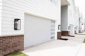 A row of modern single-story houses with white siding and brick foundations. - New! Beautifully appointed 3-bedroom townhome 30 min from Purdue - Remington IN (Remington)