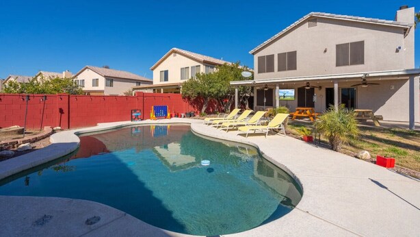 A residential property with a swimming pool, a covered patio, and a red fence. - Glendale w Pool & Games (Glendale)