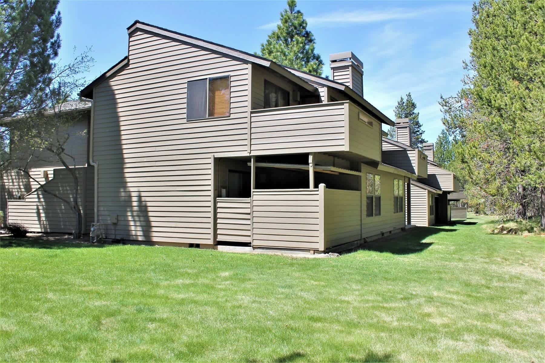 A two-story house with a large front porch and a garage.