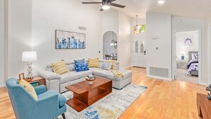 A modern living room with a sofa, coffee table, and a ceiling fan. - Mary Katherine Scottsdale (Scottsdale)