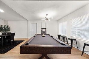 A pool table in a room with a white ceiling, a door, and a window with blinds. - Spacious 6 Bed House Airport Pet Friendly AFB (San Antonio)