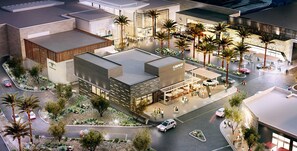 A modern commercial building with a central atrium, surrounded by palm trees and a parking area. - Sahuaro #1010 Scottsdale (Scottsdale)