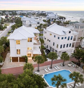 A coastal residential area with white houses, a swimming pool, and a beach in the background. - Salt & Light (Santa Rosa Beach)