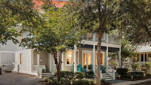 A two-story house with a porch, steps, and outdoor seating. - Om Sweet Om (Santa Rosa Beach)