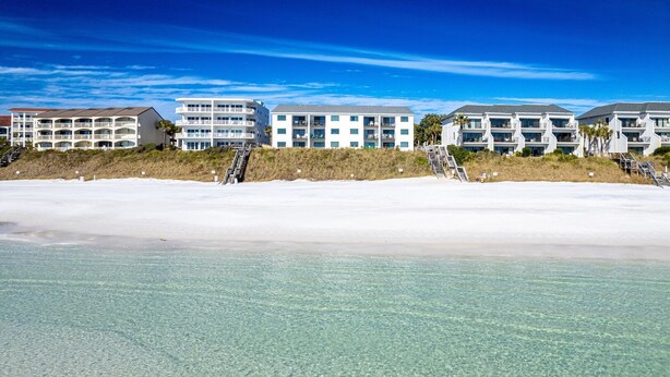 A beachfront hotel with multiple balconies and a clear view of the ocean. - Seagroovy (Santa Rosa Beach)