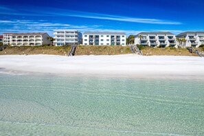 A beachfront hotel with multiple balconies and a clear view of the ocean. - Seagroovy (Santa Rosa Beach)