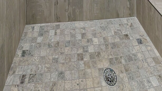 A shower area with a tiled floor and a recessed shower stall. - Free Bird @ The Oasis | Relaxed Coastal Cottage Retreat (Rockport)