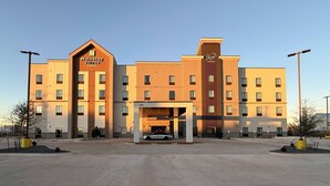 A MainStay Suites Extended Stay hotel with a modern design, multiple floors, and a parking area. - Sleep Inn - Oklahoma City Airport (Oklahoma City)