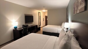A hotel room with two beds, a desk, a chair, a TV, and a lamp. - Sleep Inn - Oklahoma City Airport (Oklahoma City)