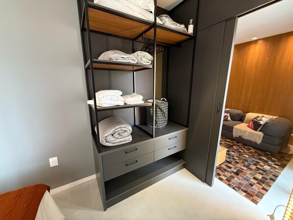 Ein moderner Kleiderschrank mit mehreren Einlegeböden, Schubladen und einer Kleiderstange.