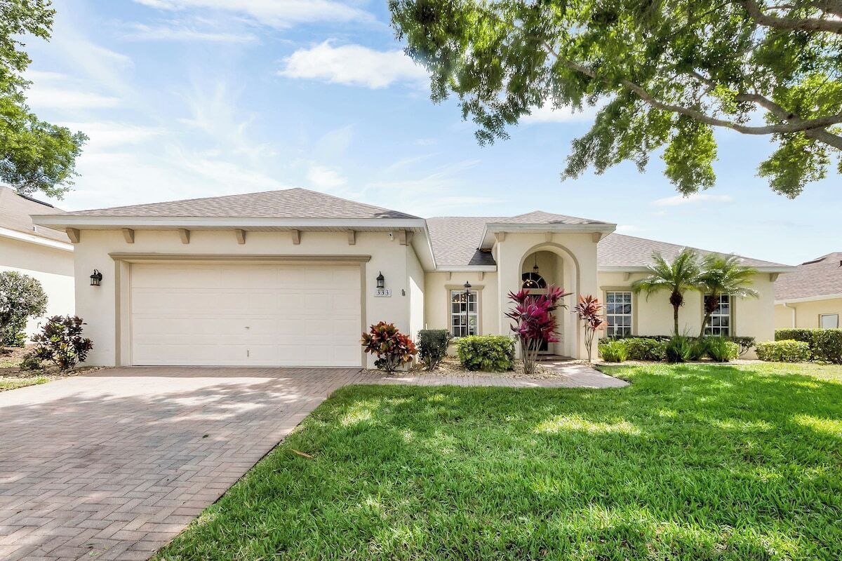 A single-story house with a garage, a front porch, and a well-maintained lawn.