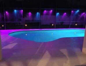A swimming pool with a curved edge, surrounded by a deck. - 333 Burford Circle Davenport (Davenport)