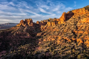A rugged mountain landscape with prominent rock formations and sparse vegetation.