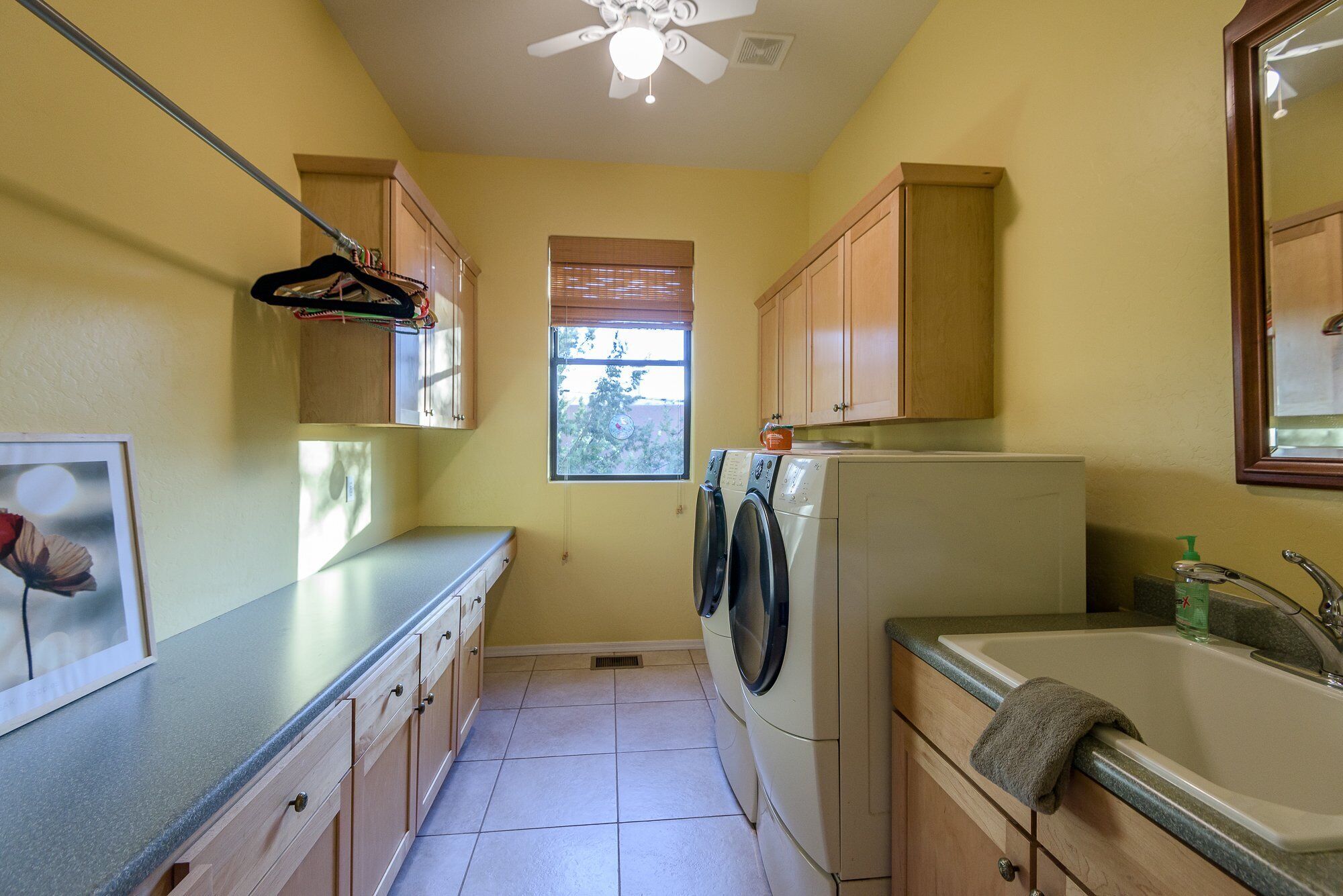A compact kitchen with a washing machine, a refrigerator, and a sink.