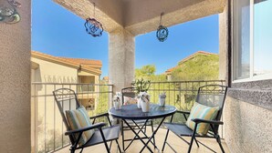 A balcony with a round table, two chairs, and a potted plant. - Southern #3116 Mesa (Mesa)