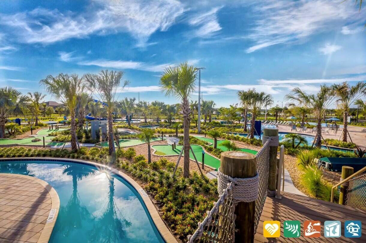Ein Poolbereich eines Resorts mit Golfplatz und Palmen.