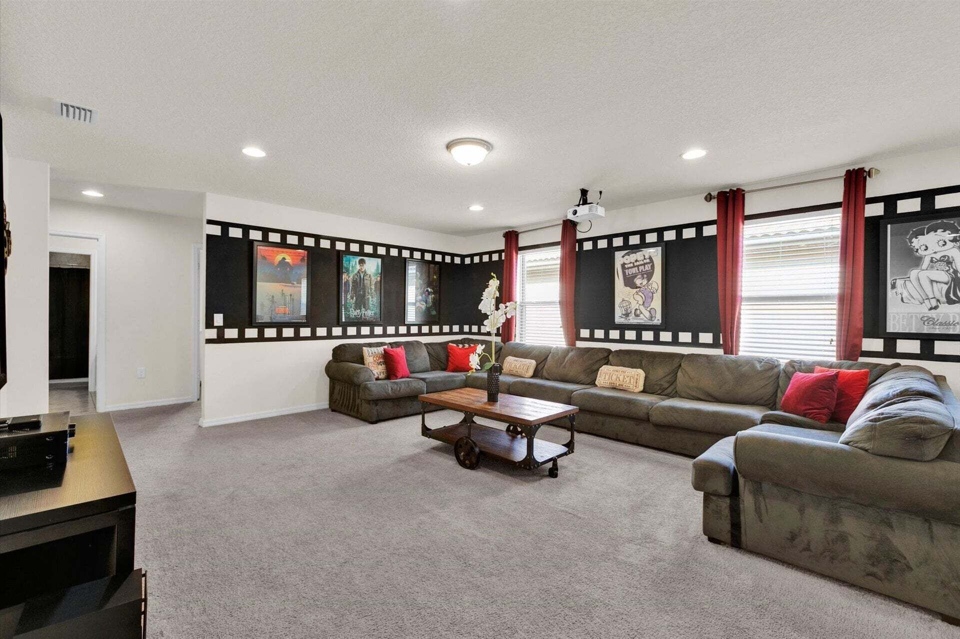A living room with a sectional sofa, a coffee table, and a flat-screen TV.