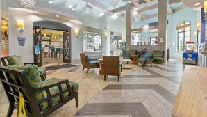 A spacious lobby with high ceilings, modern furniture, and large windows. - Mvd1562 (Davenport)