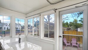 A clean, white-walled room with large windows and a door leading outside. - Historic Downtown Meets Modern Comfort (Colorado Springs)