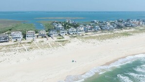 A coastal residential area with beachfront properties, a sandy beach, and a view of the ocean. - Dunecrest by Rovetravel - Family Oceanfront With Heated Pool (Westhampton Beach)
