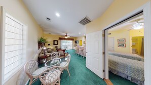 A compact living space with a dining area, kitchenette, and a bedroom. - Royal Poste Unit 2605 (Sunset Beach)
