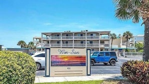 A multi-story building with a sign reading "Win-San" and the number 111. - Win-san A212 (New Smyrna Beach)
