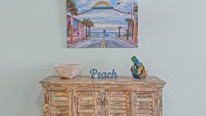 A wall with a painting of Flagler Avenue and a sign that reads "Peach." - Oceania Beach Club 704 (New Smyrna Beach)