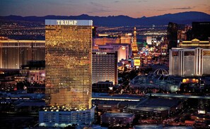 A cityscape with prominent buildings including a Trump-branded skyscraper, a Nordstrom, and a casino district. - Vegas Luxury Trump Tower Studio 2615 (Las Vegas)