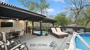 A deck with outdoor furniture, a hot tub, and a pool. - Panoramic 4BR 3B Home With Pool, Grill, Sauna & Game Room (Dallas)