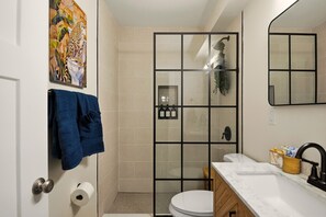 A bathroom with a shower, toilet, and sink. - asnfanfaknfckane (St. Louis)