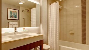 A bathroom with a sink, mirror, and shower curtain. - Hyatt place uptown (Charlotte)